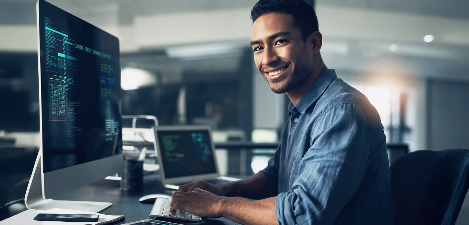 Man smiling at computer Man smiling at computer